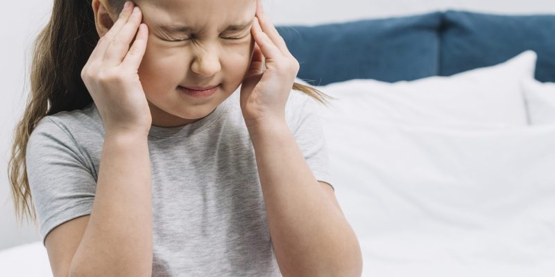 close-up-girl-sitting-bed-having-sever-pain-headache close-up-girl-sitting-bed-having-sever-pain-headache