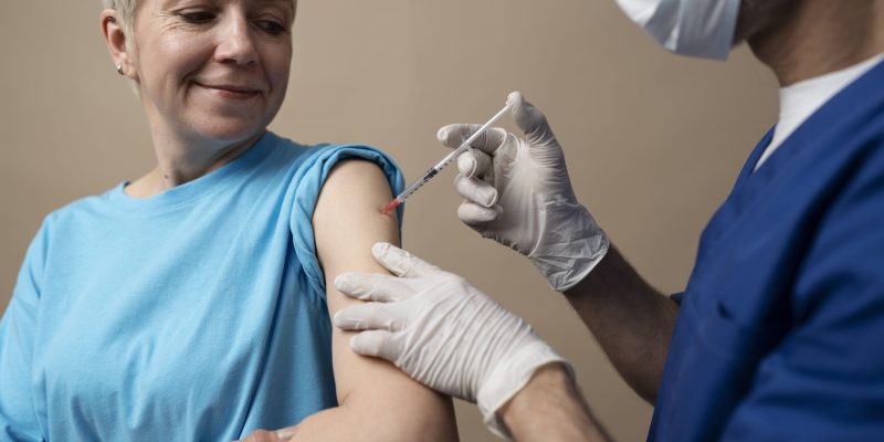 side-view-smiley-woman-getting-vaccine side-view-smiley-woman-getting-vaccine