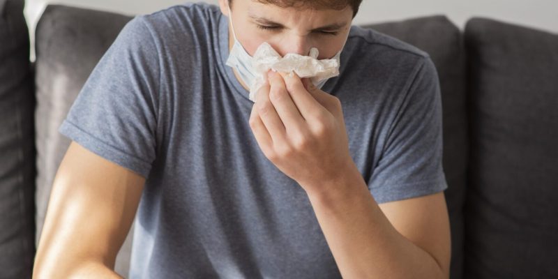 teenager-boy-blowing-his-nose teenager-boy-blowing-his-nose
